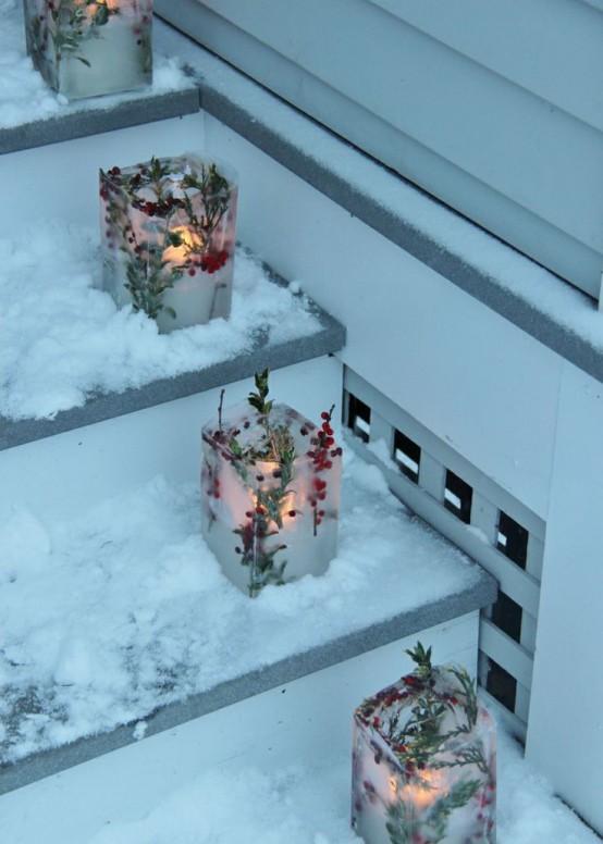 ice Christmas luminaries with twigs, evergreens and berries and candles inside are great to style your porch or steps in the garden