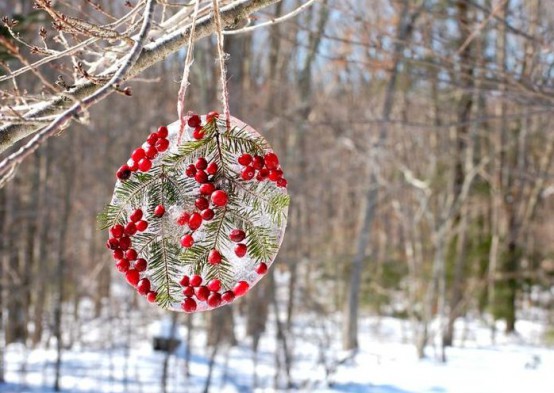 an ice piece dotted with some berries and evergreens is a nice bird feeder and just decoration for your snowy garden