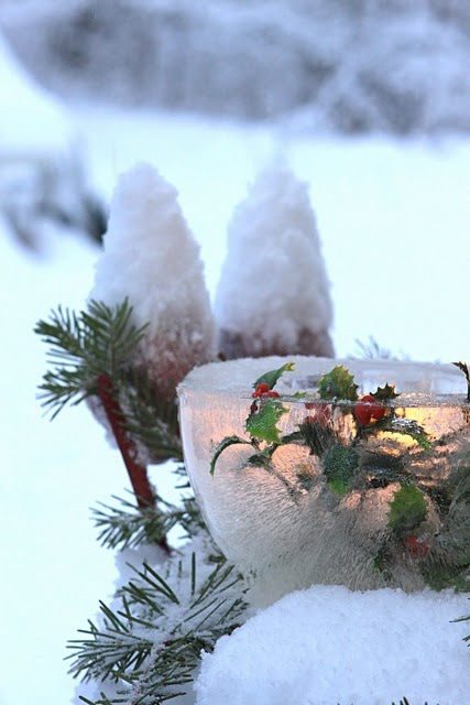 ice luminaries with greenery and berries are amazing to style your outdoor space and make it look and feel Christmassy