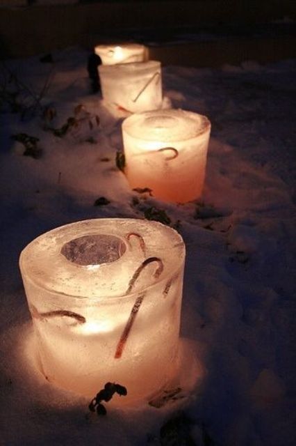 ice glass-shaped luminaries with candy canes inside will instantly make your garden look like Christmas and will add a festive feel to it