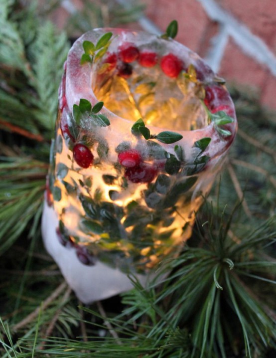 a luminarie with greenery and berries inside is a super bold and catchy idea for a winter or Christmas garden, it will add a bold touch to it