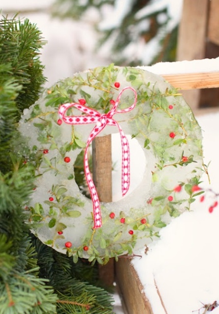 an ice Christmas wreath with greenery, berries and a red plaid bow is a lovely and bold idea done in traditional Christmas colors and with traditional Christmas elements