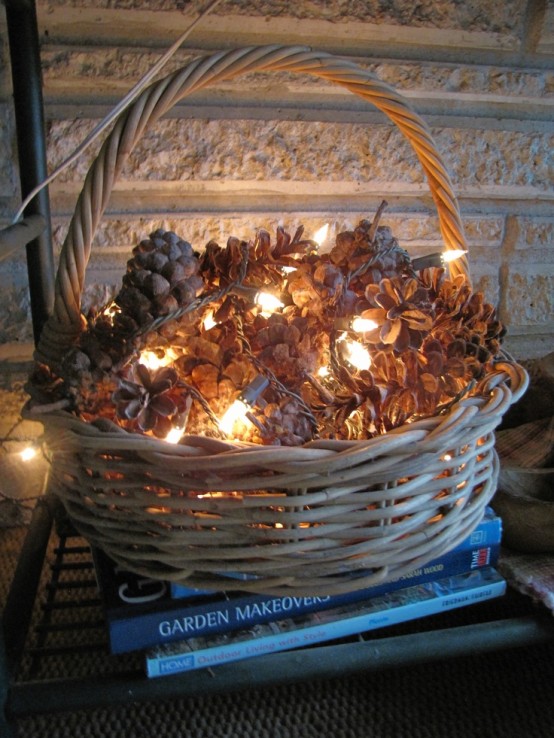 a basket filled with pinecones and lights is a cute and very simple fall or winter decoration