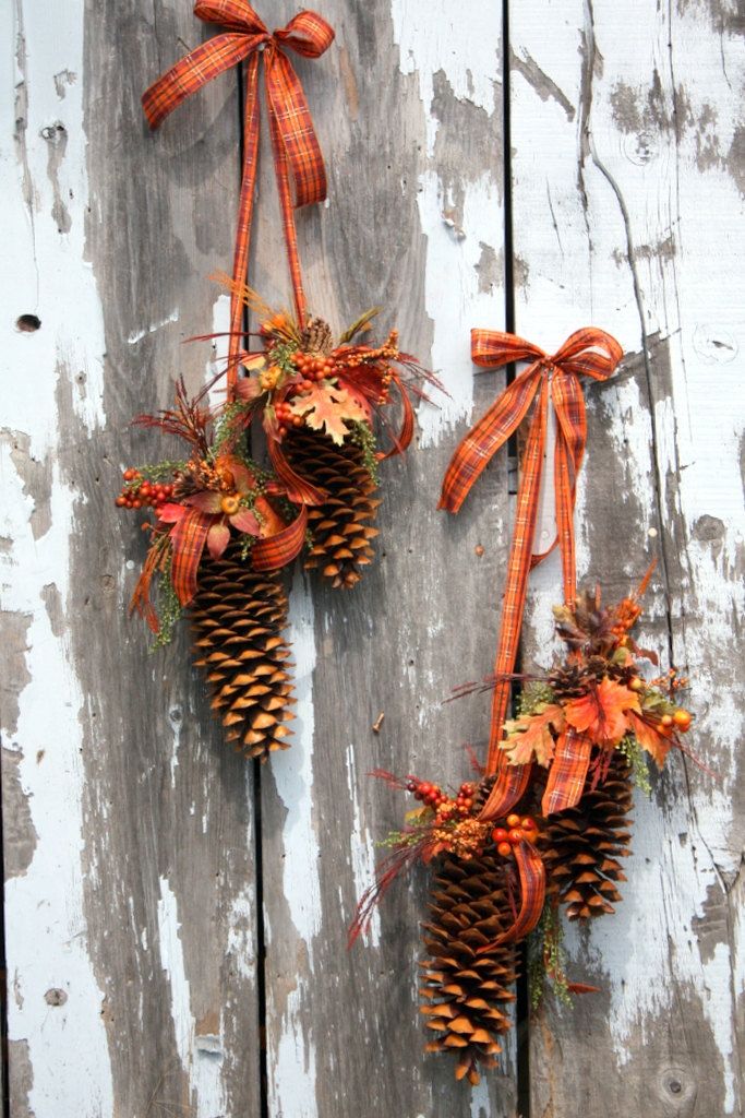 fall posies made of hanging pinecones and faux blooms, berries and orange plaid ribbons feel like fall itself