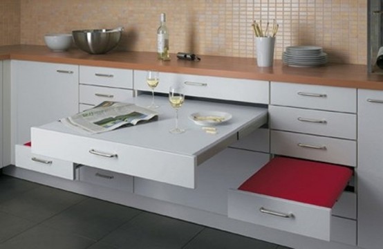 a small contemporary kitchen with drawers that include a table and seats that can be hidden anytime