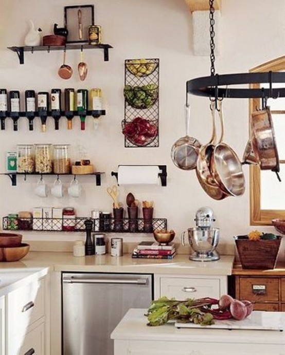 a stylish and welcoming rustic kitchen with white cabinets, open shelves, a hanging holder for pans and touches of wood