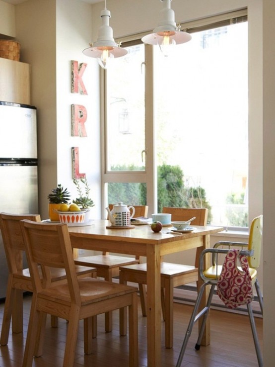 a simple and small dining space by the window, with a wooden dining set and some signs