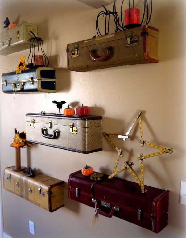 a unique gallery wall of pieces of vintage suitcases as display shelves that show off some lovely fall decor