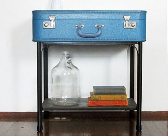 a tiered side table of a blue vintage suitcase with a shelf gives a lot of storage space and cna be a nice solution for an entryway