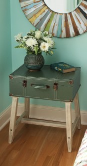 a chic and stylish bedside table of a vintage suitcase on tall legs, with storage and not only is a stylish DIY for a vintage space