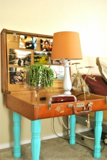 a vintage suitcase turned into a side table, with bold turquoise legs, some photos, greenery, a table lamp is a very interesting shabby chic solution