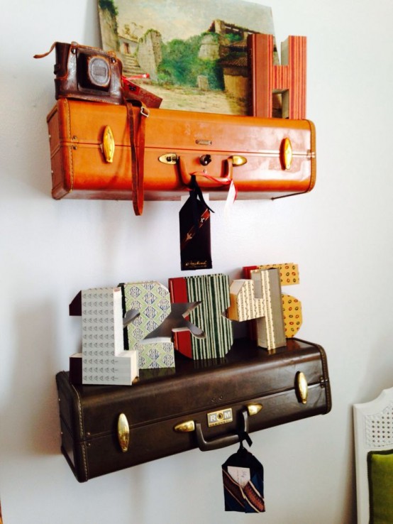 pretty shelves made of an orange and a brown suitcase piece that are used to display various decor on the wall