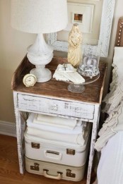 little suitcases stacked under the nightstand are great for storage, they will let you not to clutter the space