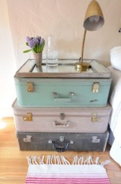 a pretty shabby chic pastel-colored nightstand composed of vintage suitcases and with a mirror tabletop is a lovely and easy idea