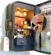 a vintage suitcase attached to the wall as a storage unit with lights and a mirror is a tiny idea of a vanity for a small room