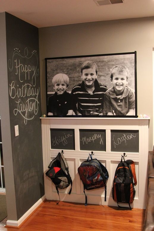 an oversized black and white photo in a black frame attached over a bag rack is a lovely decoration
