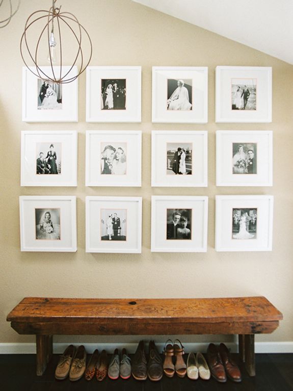 a stylish gallery wall with black and white photos in matching white frames over the bench form a cool composition