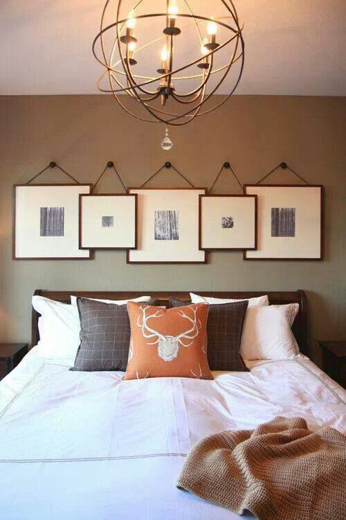 black and white photos in matching frames over the headboard hanging on each other forming a cool gallery wall