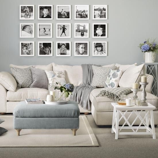 an elegant gallery wall with black and white photos framed in white is a stylish idea to rock