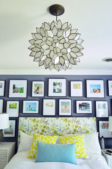 a bright gallery wall with color pics in matching black frames over the bed to make the space bolder and cooler