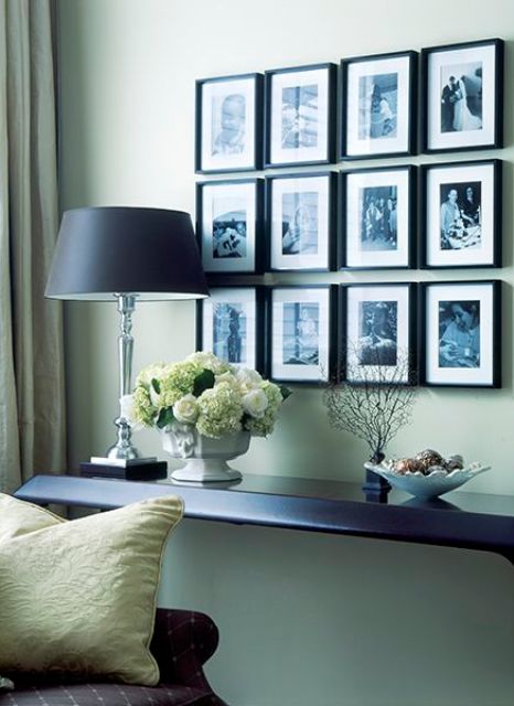 a stylish black and white gallery wall with photos in black frames is always a good idea to decorate and personalize your space a bit