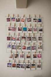 a Polaroid gallery wall with photos hanging on wires and attached with clothespins is a fun and casual idea for any space