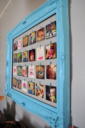 a vintage blue frame with wire and colorful photos attached with clothespins is an elegant and refined decor idea