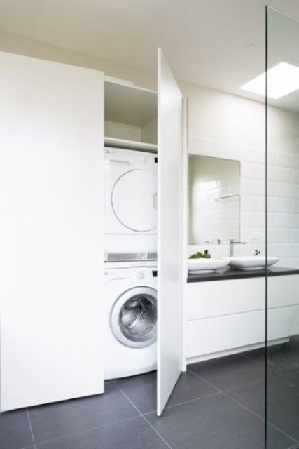 One large cabinet in a bathroom could fit a washer, a dryer and even hide some laundry bins.