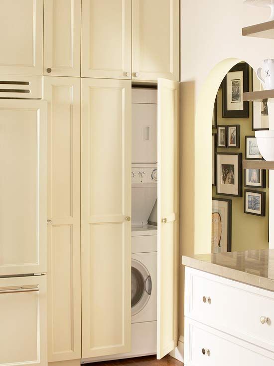 A washer and a dryer on top of each other could be placed in a tall kitchen cabinet.
