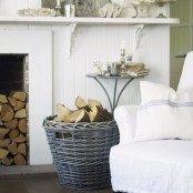 a basket with firewood next to a non-working fireplace is a very nice and lovely idea for any space, it adds coziness