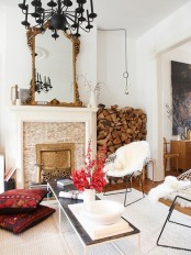 an eclectic space with a non-working and very refined fireplace and firewood stored between it and the wall for maximal coziness