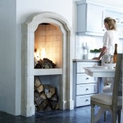 an arched vintage hearth and a built-in niche for firewood under it is a very cool way to make vintage look modern