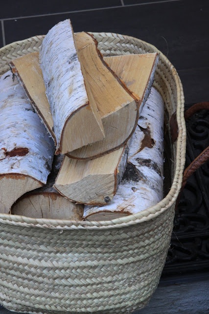 a basket with firewood is a lovely idea for a modern farmhouse space, it can be used both indoors and outdoors