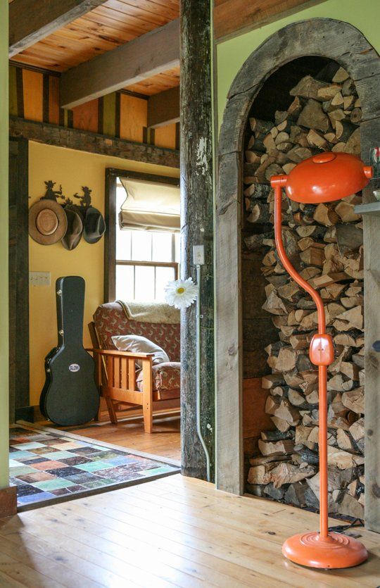 a large arched niche with a wooden frame for storing firewood is a lovely decor feature for any kind of interior