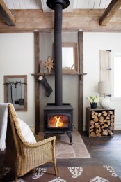 a vintage fireplace, a wooden box with firewood for a cozy rustic feel in the space