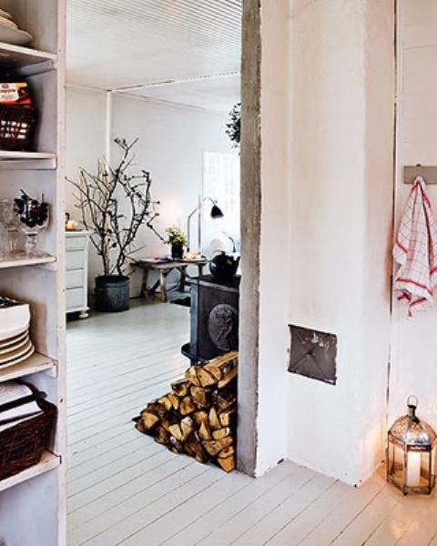 firewood stored right on the floor is a cool solution for a Nordic, rustic or woodland-inspired interior and you needn't puzzle over where to place it