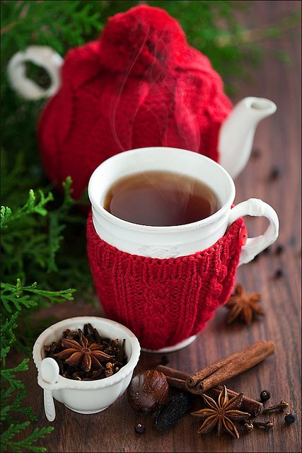 a tea pot and a mug dressed up in red knit covers look amazingly festive, and these cozies won't let your tea get cold fast