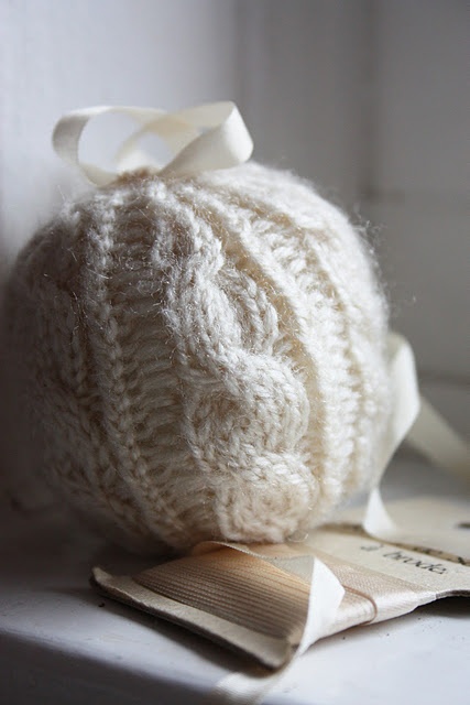 a white braided Christmas ornament with a ribbon bow is a cute and ethereal decor idea for the holidays