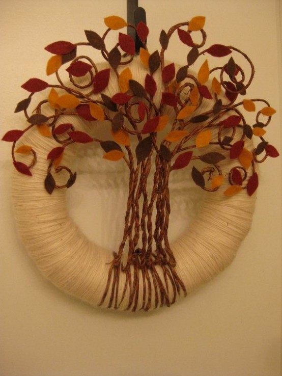 a unique fall wreath covered with neutral yarn, a tree with colorful fabric leaves and twine is a bold idea