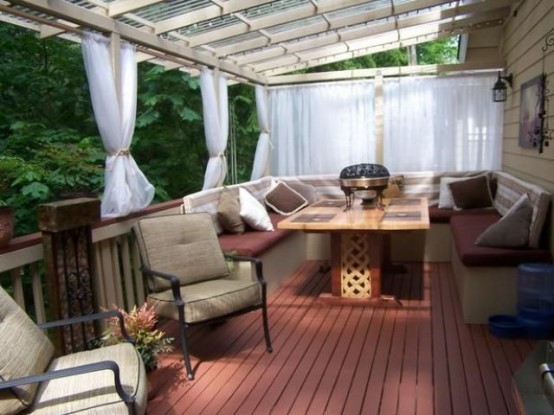 a cozy outdoor dining space that features mosquito net curtains to keep bugs away from people and food