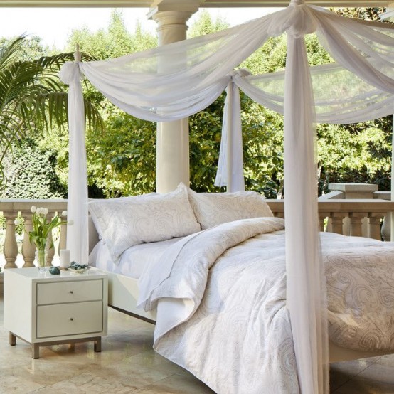 a bed placed outdoors and covered with mosquito net curtains and a canopy is a gorgeous idea for having a nap outside
