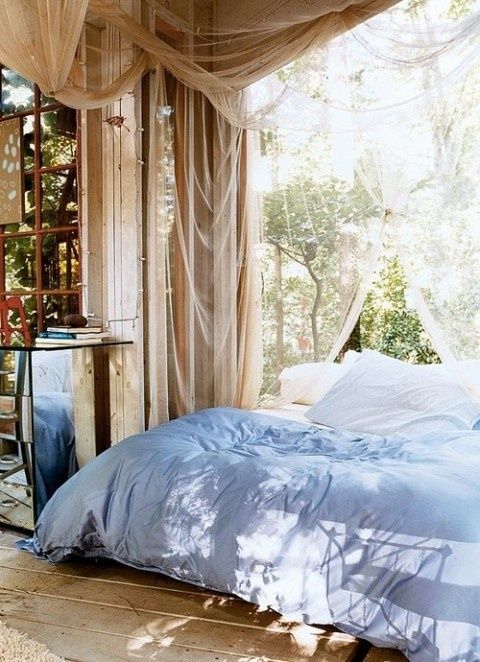 an outdoor bedroom with mosquito net curtains everywhere to avoid bugs while sleeping