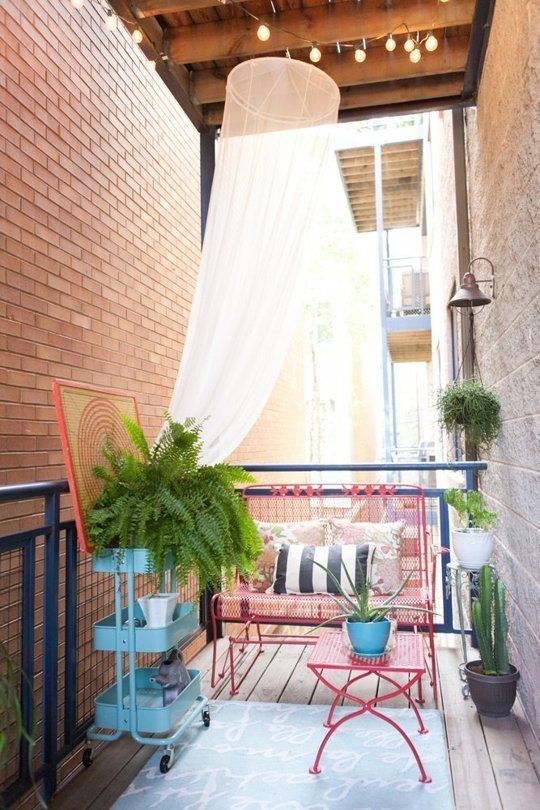 a small balcony with a mosquito net over the balcony, which is part of decor