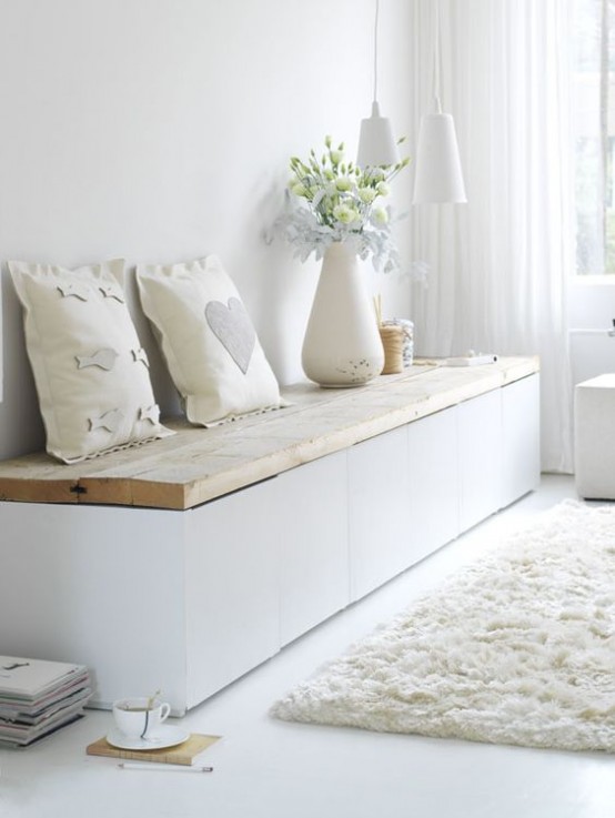 a light-filled shabby chic meets Nordic entryway with a storage bench, pendant lamps and a faux fur rug