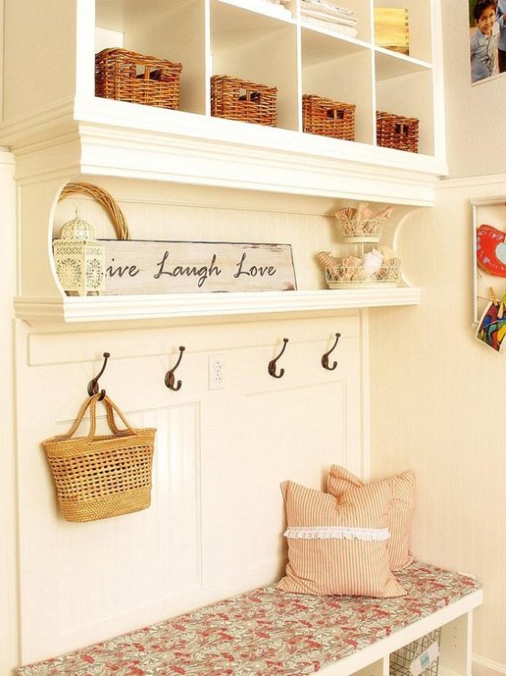 a neutral shabby chic meets farmhouse entryway with an open storage unit with a daybed, some signs and baskets for storage