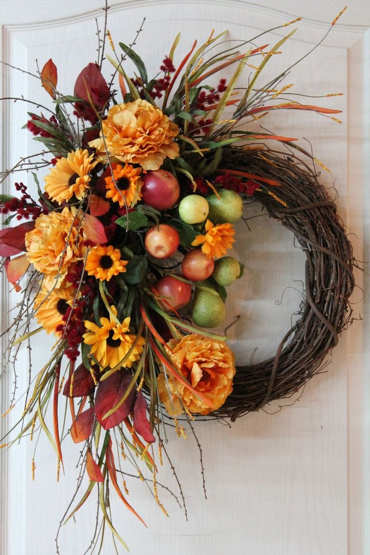a bright and lush fall wreath of vine, faux blooms, leaves, twigs and apples looks bold and very cool