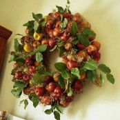a rustic fall wreath of hay, faux leaves and apples feels very autumnal and very cozy