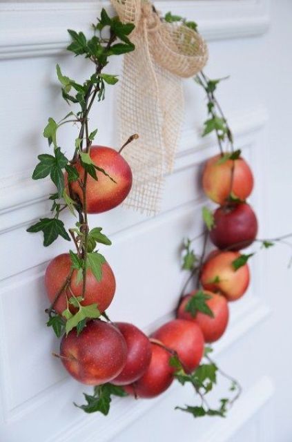 an all natural mini wreath of natural apples and foliage plus a burlap bow is small, cute and very edible