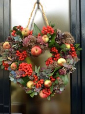a non-typical and textural fall wreath of apples, berries, dried blooms and foliage will stand out a lot