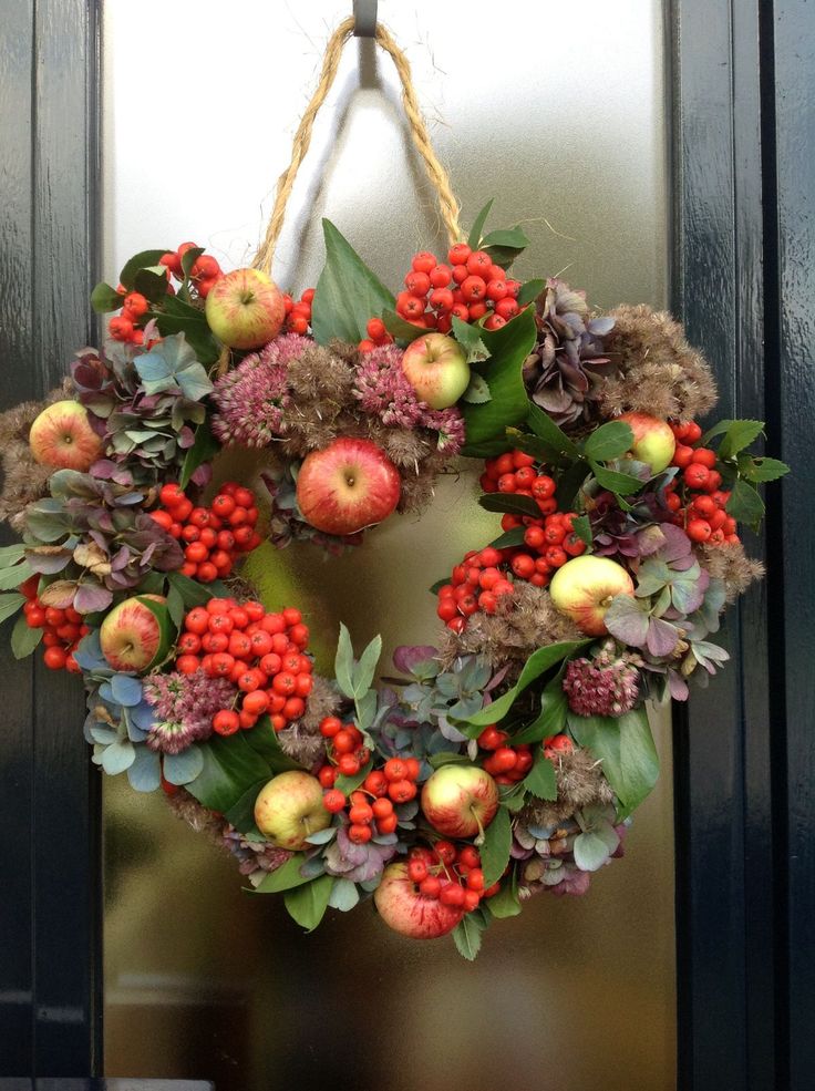 a non typical and textural fall wreath of apples, berries, dried blooms and foliage will stand out a lot